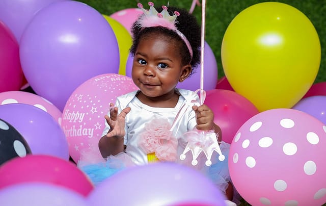 toddler with balloons