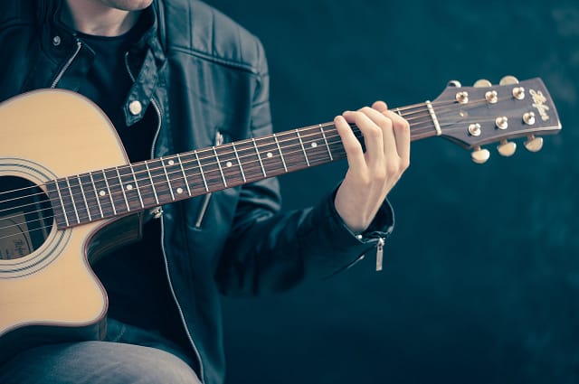 playing acoustic guitars